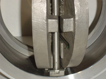 Lapped body with shock bumpers retainerless check valve
