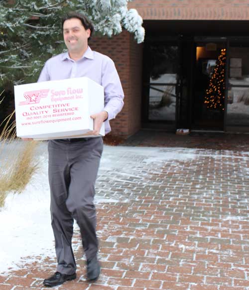 Justin Leblanc loads some Sure Flow contributions to the Salvation Army truck.