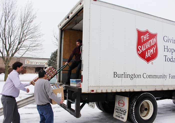 Loading the Salvation Army truck with the Sure Flow Holiday Food Drive contributions