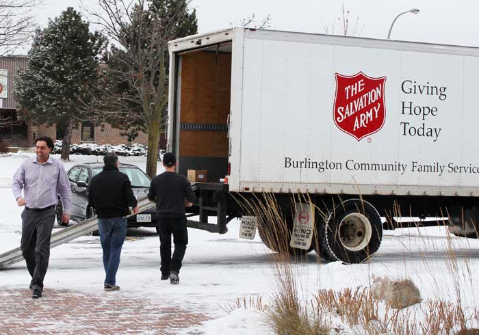 Loading the Salvation Army truck with the Sure Flow Holiday Food Drive contributions