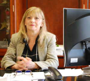 Penni Boxall President of Sure Flow image at her desk