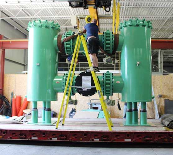 large dual basket strainer being loaded onto flatbed