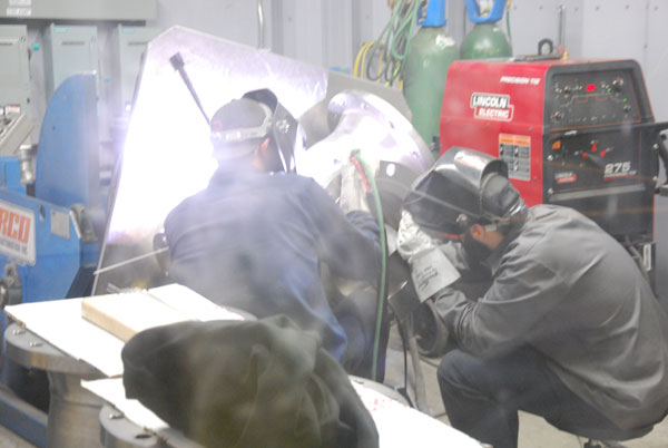 artists at work welding titanium in clean welding room
